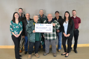 Group of people accepting a check for a donation.