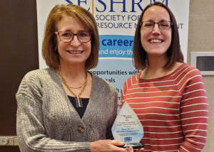 two women with an award