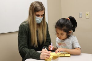 woman teaching child